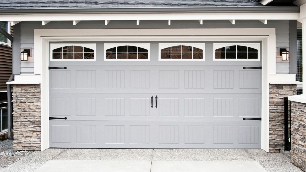 a door leading to a white door with a white door. features garage door services garage door repair garage door installation garage door spring repair new garage doors provided by Retrak Door Service.