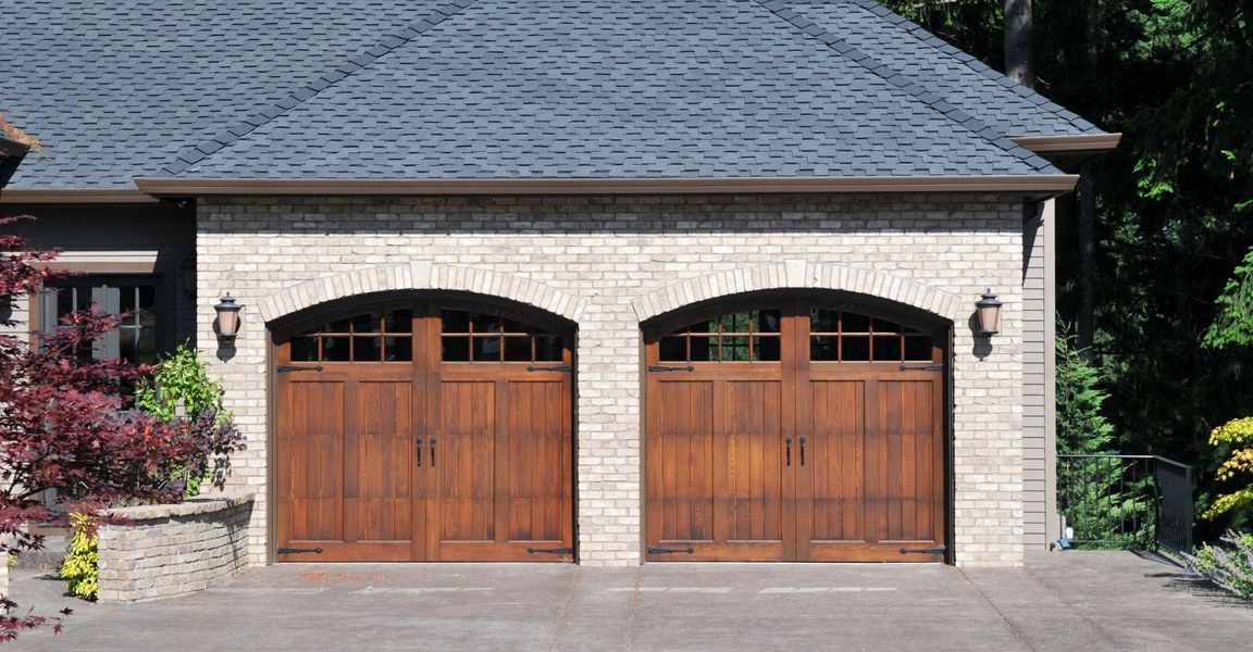 A large brick building with a door open. showcasing features like garage door services garage door repair garage door installation.