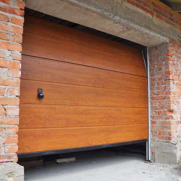 A wooden door leading to a brick building. showcasing features like garage door services garage door repair garage door installation.