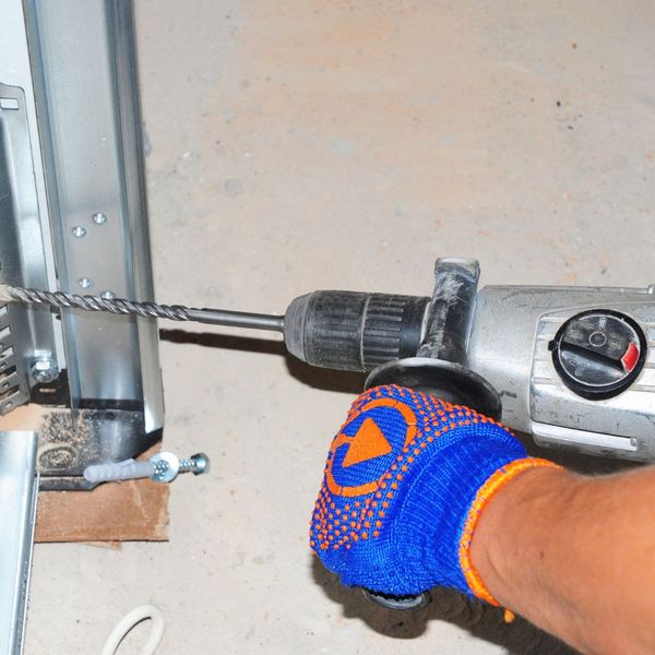 a person is holding a pair of scissors. features garage door services garage door repair garage door installation provided by Retrak Door Service.