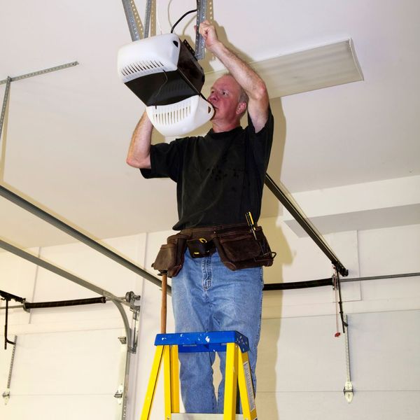 This scene from Lakewood, CO shows a man is doing a trick on a crane. with features such as garage door services garage door repair garage door installation garage door spring repair.