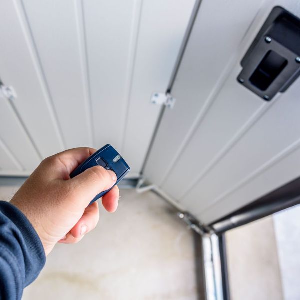 A person holding a cell phone in their hand. showcasing features like garage door services garage door repair garage door installation garage door spring repair.